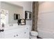 Bathroom featuring modern vanity, a shower-tub combo, and decorative accents at 1771 Jordan Brook Dr, Lawrenceville, GA 30043