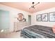 A serene bedroom with a dresser and walk-in closet, featuring stylish decor, soft colors, and modern lighting at 1771 Jordan Brook Dr, Lawrenceville, GA 30043