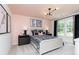 Charming bedroom featuring a stylish bed, modern lighting fixture, and a bright window view to the outdoors at 1771 Jordan Brook Dr, Lawrenceville, GA 30043