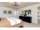 Beautiful bedroom showcasing modern chandelier, dresser with decor, and serene color palette at 1771 Jordan Brook Dr, Lawrenceville, GA 30043