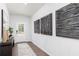 Stylish entryway with textured wall art, wood-look flooring, and ample natural light at 1771 Jordan Brook Dr, Lawrenceville, GA 30043