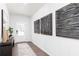 Stylish entryway with textured wall art, wood-look flooring, and ample natural light at 1771 Jordan Brook Dr, Lawrenceville, GA 30043