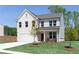 Charming two-story home boasting a lush green lawn and a classic brick exterior at 1771 Jordan Brook Dr, Lawrenceville, GA 30043