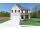 Beautiful two-story home featuring a well-manicured lawn and a white brick facade at 1771 Jordan Brook Dr, Lawrenceville, GA 30043