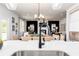 Open-concept kitchen and dining area with a black faucet, white countertops, and dining table at 1771 Jordan Brook Dr, Lawrenceville, GA 30043