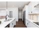Modern kitchen featuring white cabinets, stainless steel appliances, quartz countertops, and hardwood floors at 1771 Jordan Brook Dr, Lawrenceville, GA 30043