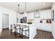 Bright kitchen featuring white cabinetry, stainless steel appliances, and a center island at 1771 Jordan Brook Dr, Lawrenceville, GA 30043