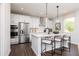 Modern kitchen with stainless steel appliances, a large island and pendant lighting at 1771 Jordan Brook Dr, Lawrenceville, GA 30043