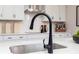 Close-up of a kitchen sink with a black faucet and subway tile backsplash at 1771 Jordan Brook Dr, Lawrenceville, GA 30043