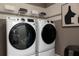 Modern laundry room equipped with sleek, front-load washer and dryer units, maximizing efficiency and convenience at 1771 Jordan Brook Dr, Lawrenceville, GA 30043