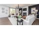 Spacious living room with white sofas, a fireplace, and a black accent wall at 1771 Jordan Brook Dr, Lawrenceville, GA 30043