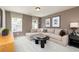 Comfortable living room showcasing a large sectional sofa, a round coffee table, and neutral tones at 1771 Jordan Brook Dr, Lawrenceville, GA 30043