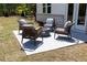 Cozy patio featuring stylish wicker chairs arranged around a modern fire pit, perfect for outdoor relaxation at 1771 Jordan Brook Dr, Lawrenceville, GA 30043