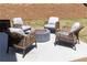 Outdoor patio featuring wicker chairs around a fire pit and a tranquil backyard setting at 1771 Jordan Brook Dr, Lawrenceville, GA 30043
