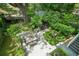 Aerial view of a backyard with stone patio and outdoor dining area surrounded by lush landscaping at 20 S Prado Ne, Atlanta, GA 30309