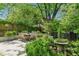 Inviting stone patio offers outdoor dining with wood table and chairs surrounded by lush landscaping at 20 S Prado Ne, Atlanta, GA 30309