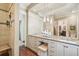 Bathroom featuring cabinetry, vanity and sinks, sconces, and access to tiled shower at 20 S Prado Ne, Atlanta, GA 30309