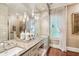 Elegant bathroom vanity with dual sinks, pendant lighting, and neutral color palette at 20 S Prado Ne, Atlanta, GA 30309