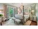 Serene bedroom boasts a private balcony, chandelier, and decorative mirrors for added charm at 20 S Prado Ne, Atlanta, GA 30309