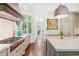 Well-equipped kitchen features stainless steel appliances, custom cabinets, and large windows for natural light at 20 S Prado Ne, Atlanta, GA 30309