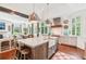 Spacious kitchen with a large center island, farmhouse sink, stainless steel appliances, and dark wood floors at 20 S Prado Ne, Atlanta, GA 30309