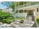 Back of home with double porches and outdoor space with a wood table and chairs at 20 S Prado Ne, Atlanta, GA 30309