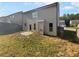 A view of the home's back exterior featuring a grassy backyard, a concrete patio, and fencing at 4428 Belcamp Rd, Fairburn, GA 30213
