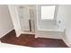 This is a standard bathroom with a shower, tub, and wooden floors at 4428 Belcamp Rd, Fairburn, GA 30213