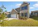 Charming two-story home with a lush, green lawn and beautiful blue shutters on the windows at 4428 Belcamp Rd, Fairburn, GA 30213