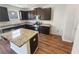 Modern kitchen with granite countertops, stainless steel appliances, dark wood cabinets, and hardwood floors at 4428 Belcamp Rd, Fairburn, GA 30213