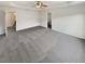 Spacious main bedroom with a ceiling fan, tray ceiling, and light gray carpet at 4428 Belcamp Rd, Fairburn, GA 30213