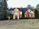 Stunning brick home with manicured lawn and elegant architectural details at 20 Rosemont Pkwy, Covington, GA 30016