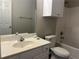 Bright bathroom with a tub, shower, toilet and single sink vanity with white cabinets at 3835 Portico Run Dr, Buford, GA 30519