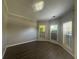 Bedroom with dark wood-look flooring and multiple windows providing ample natural light at 3835 Portico Run Dr, Buford, GA 30519