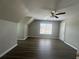 This spacious bedroom features wood-look flooring, neutral colored walls, and a ceiling fan at 3835 Portico Run Dr, Buford, GA 30519