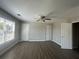 This room features multiple closets, wood-look floors, neutral colored walls, and a ceiling fan at 3835 Portico Run Dr, Buford, GA 30519