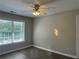 Bedroom with wood-look flooring, neutral paint, ceiling fan, and a closet at 3835 Portico Run Dr, Buford, GA 30519