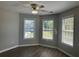Bedroom with dark wood-look flooring, neutral paint, and bright, natural light at 3835 Portico Run Dr, Buford, GA 30519