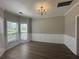 Elegant dining room features dark flooring, a chandelier, and abundant natural light at 3835 Portico Run Dr, Buford, GA 30519