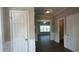 Inviting foyer features neutral paint, white doors, and dark wood-look flooring at 3835 Portico Run Dr, Buford, GA 30519