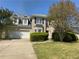 Traditional brick two-story home features a manicured lawn and attached two-car garage at 3835 Portico Run Dr, Buford, GA 30519