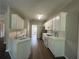 Well-lit kitchen with white cabinets, stainless steel appliances, and modern fixtures at 3835 Portico Run Dr, Buford, GA 30519