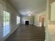 Spacious living room features hardwood flooring, a fireplace, and large windows at 3835 Portico Run Dr, Buford, GA 30519