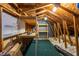 A versatile attic space equipped with pegboards, tables, shelves and green carpet at 405 Mcgill Park Ne Ave, Atlanta, GA 30312