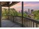 Relaxing balcony view overlooking lush greenery and a stunning city skyline at dusk at 405 Mcgill Park Ne Ave, Atlanta, GA 30312
