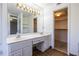 Bathroom vanity with dual sinks, bright lighting and a large mirror at 405 Mcgill Park Ne Ave, Atlanta, GA 30312