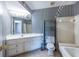 Bathroom featuring a large vanity, ceramic floors, and traditional tub with shower at 405 Mcgill Park Ne Ave, Atlanta, GA 30312