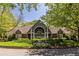Inviting clubhouse with meticulously maintained landscaping, including lush lawns and colorful flower beds at 405 Mcgill Park Ne Ave, Atlanta, GA 30312