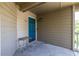 Cozy front porch featuring a blue door, small table, and neutral siding at 405 Mcgill Park Ne Ave, Atlanta, GA 30312