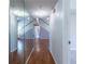 Hallway with hardwood floors, mirrored closet doors, and staircase to the upper level at 405 Mcgill Park Ne Ave, Atlanta, GA 30312